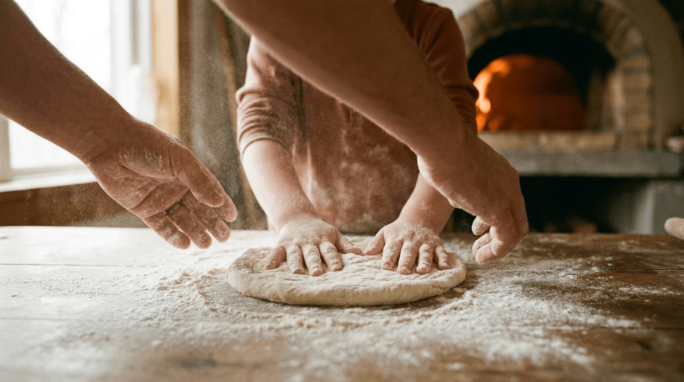 A child's flour-dusted hands shaping dough.
